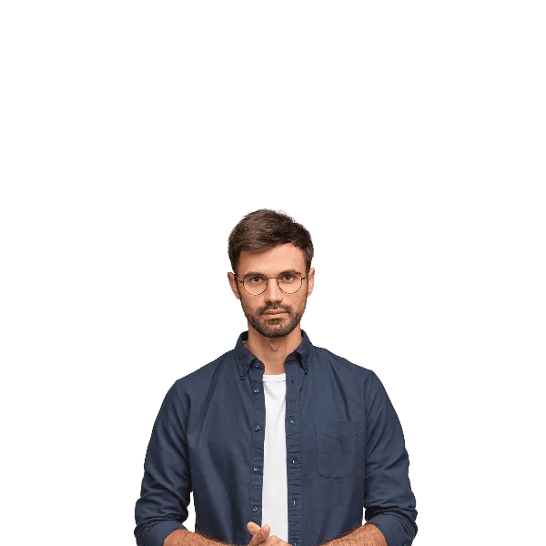 A man stands with hands clasped, looking directly at the camera.